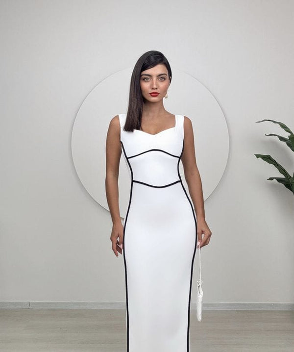 "Chic sleeveless white dress with black contour lines and a sleek, body-hugging silhouette