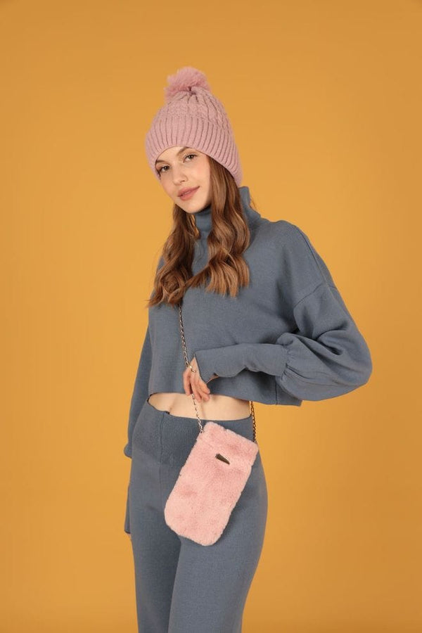 "Small fluffy pink crossbody bag with a chain strap."