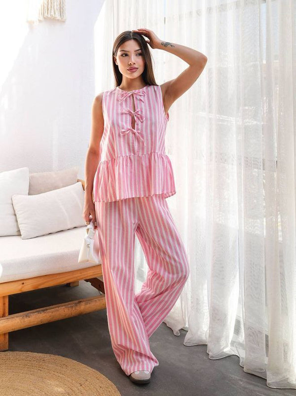 "Sleeveless top paired with high-waisted long trousers — a sleek and modern set.