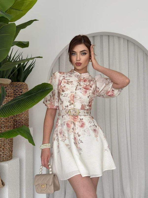 A charming and elegant look featuring a floral mini dress with puff sleeves and a belted waist, radiating femininity and timeless grace—perfect for a fresh, sophisticated outing